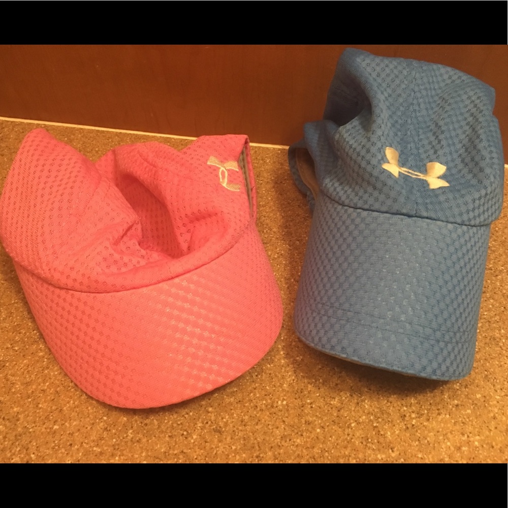 Under Armour Women’s hats. One pink one blue.